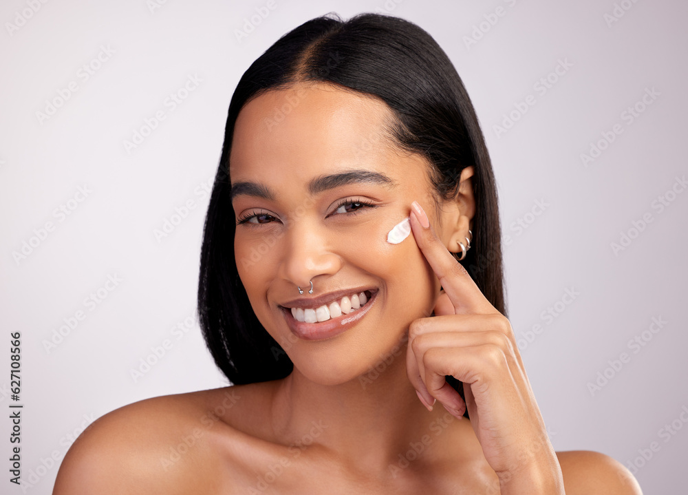 Happy woman, portrait and face cream for skincare, beauty or cosmetics against a grey studio backgro