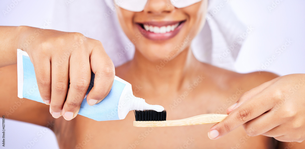 Toothpaste, toothbrush and woman with an oral care routine in a studio for health and wellness. Smil