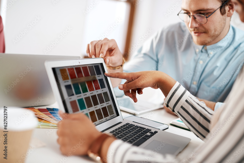 Help me choose a colour. Cropped shot of two young businesspeople sitting together and working with 