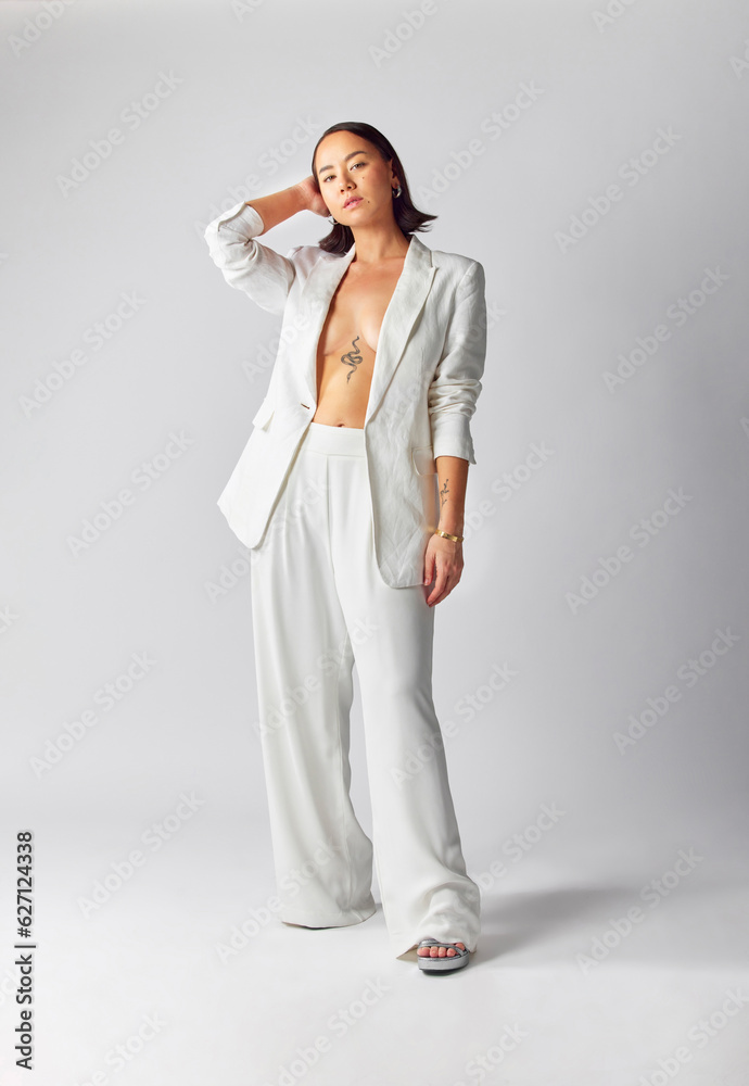 Suit, style and asian woman with fashion in portrait or confident in studio or white background with