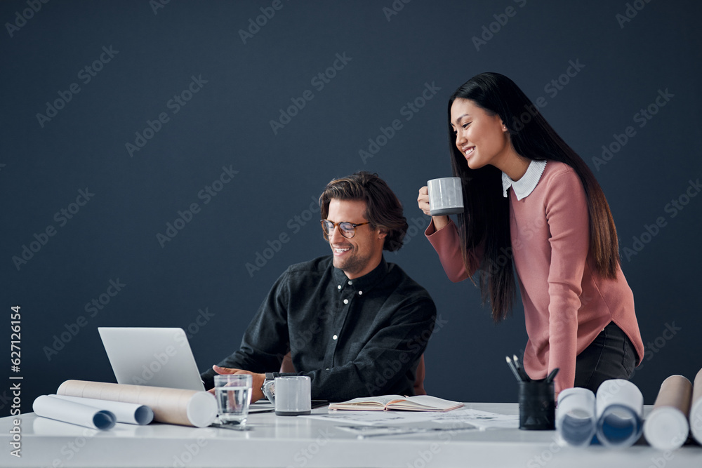 How do you like the look of that. Shot of two young architects going over designs on a laptop togeth