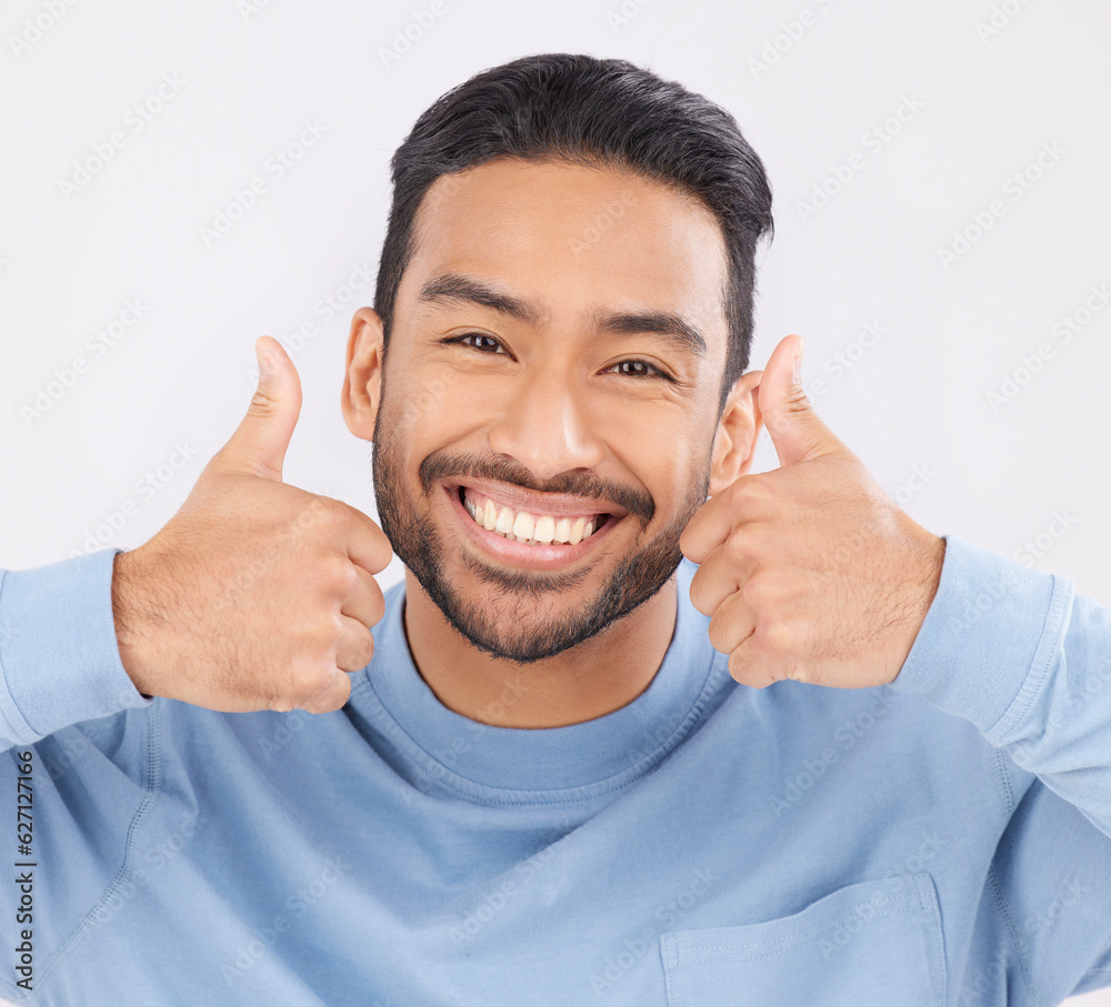 Thumbs up, portrait and asian man happy in studio with hand, sign and thank you on grey background. 