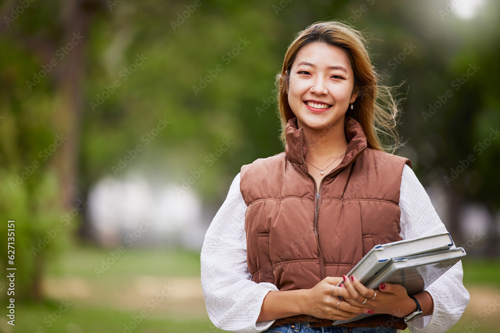 Asian student, portrait and woman with books for learning, education and outdoor on university campu