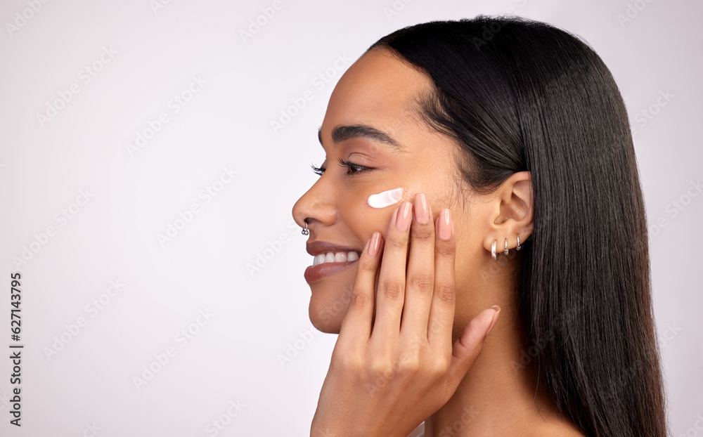 Happy woman, face and cream on mockup for skincare, beauty or cosmetics against a grey studio backgr