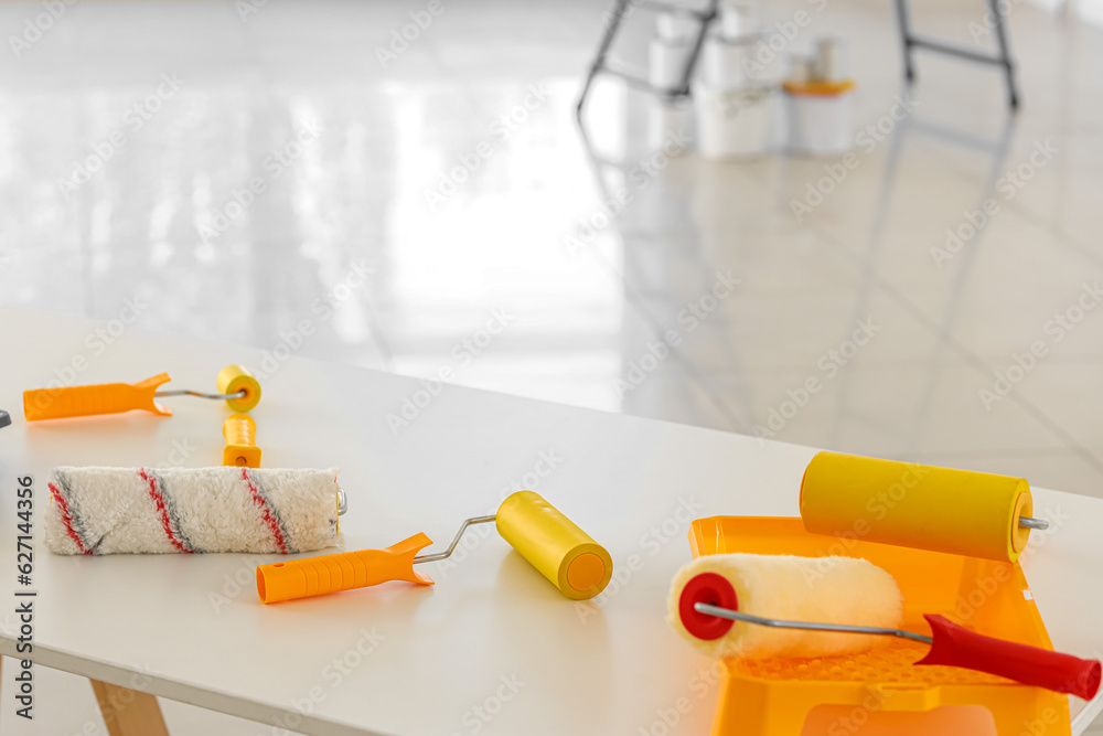 Paint rollers on table in room, closeup