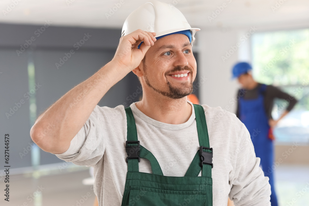 Male builder working in room