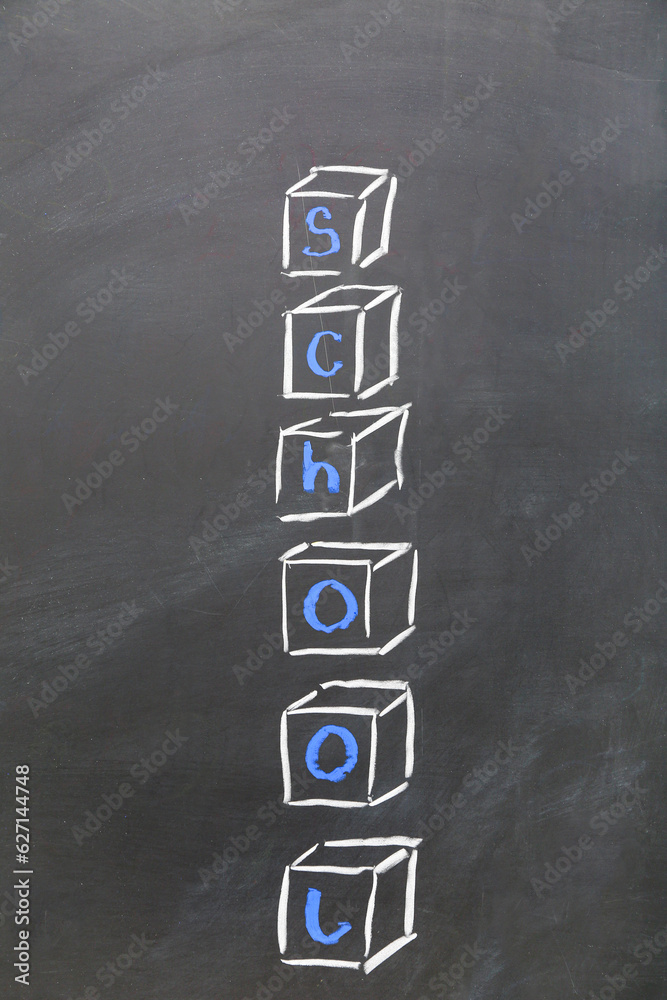 Drawn cubes with word SCHOOL on black chalkboard