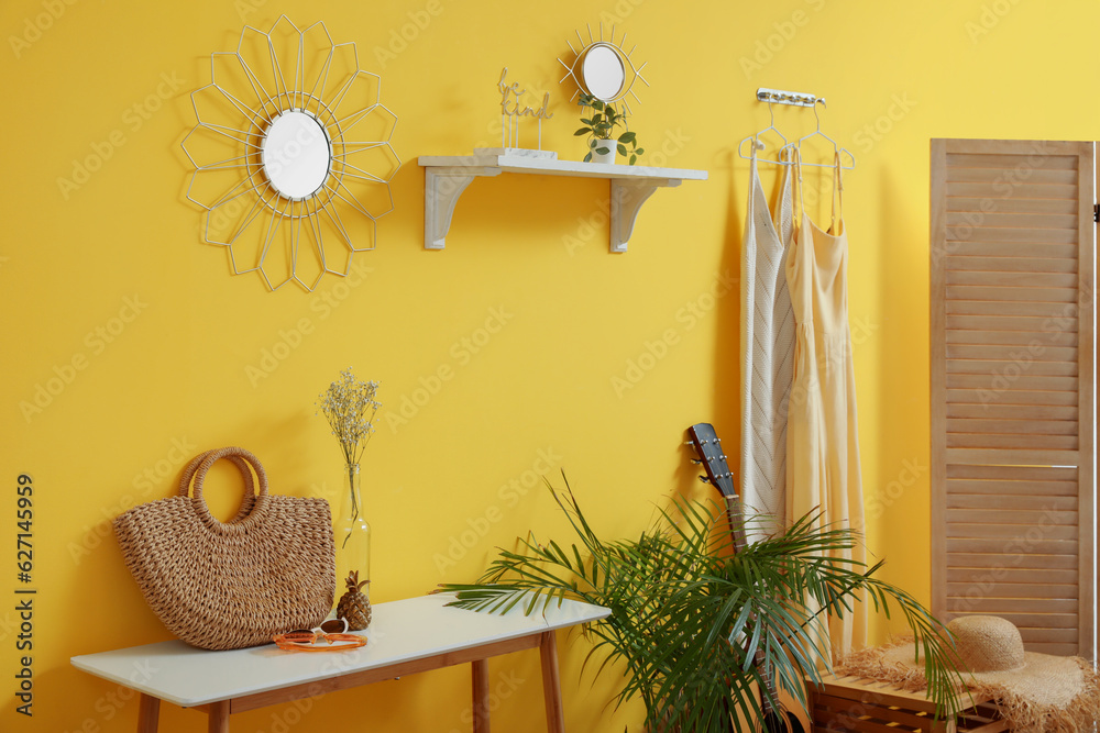 Interior of stylish hallway with mirror, shelf and hook rack