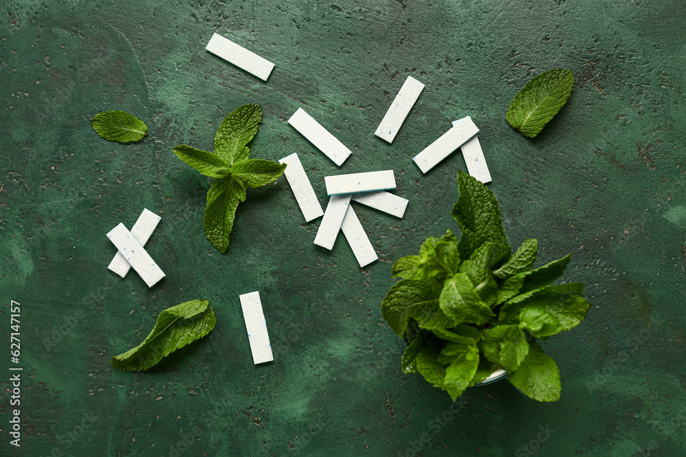 Fresh chewing gums with mint on green background