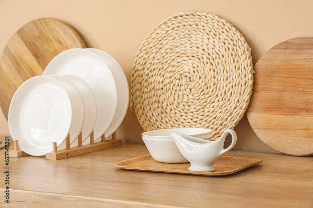 Kitchen counter with plate rack, clean dishes and cutting boards