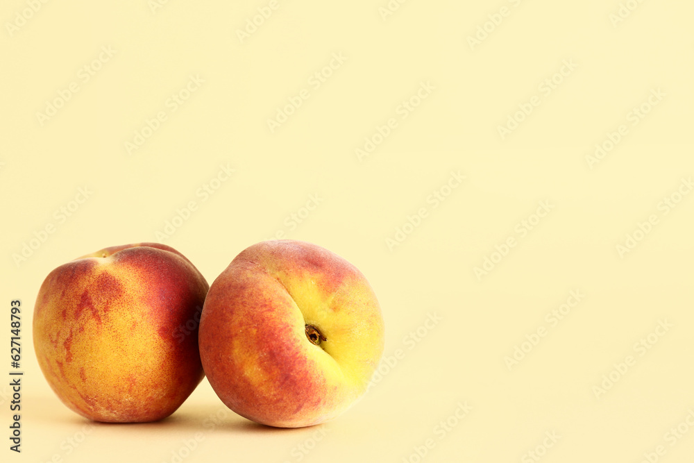 Sweet peaches on yellow background