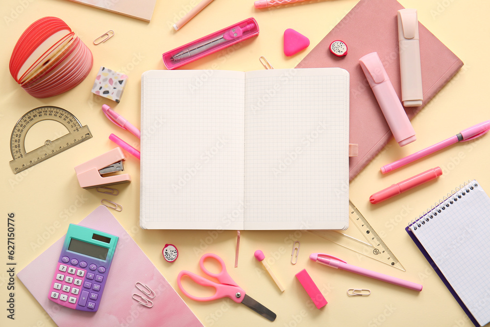 Composition with blank notebook and different school stationery on beige background