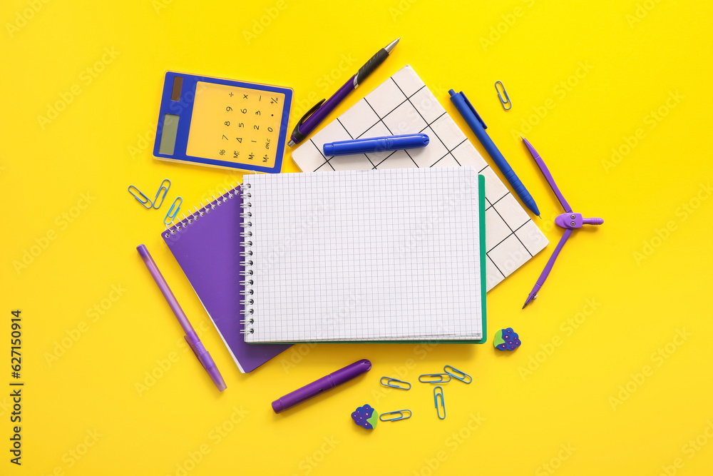 Composition with blank notebook and school stationery on yellow background