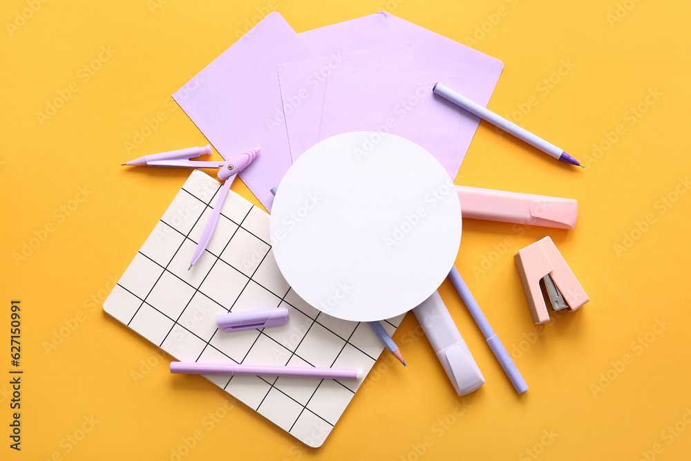 Composition with blank paper sheet and different school stationery on orange background