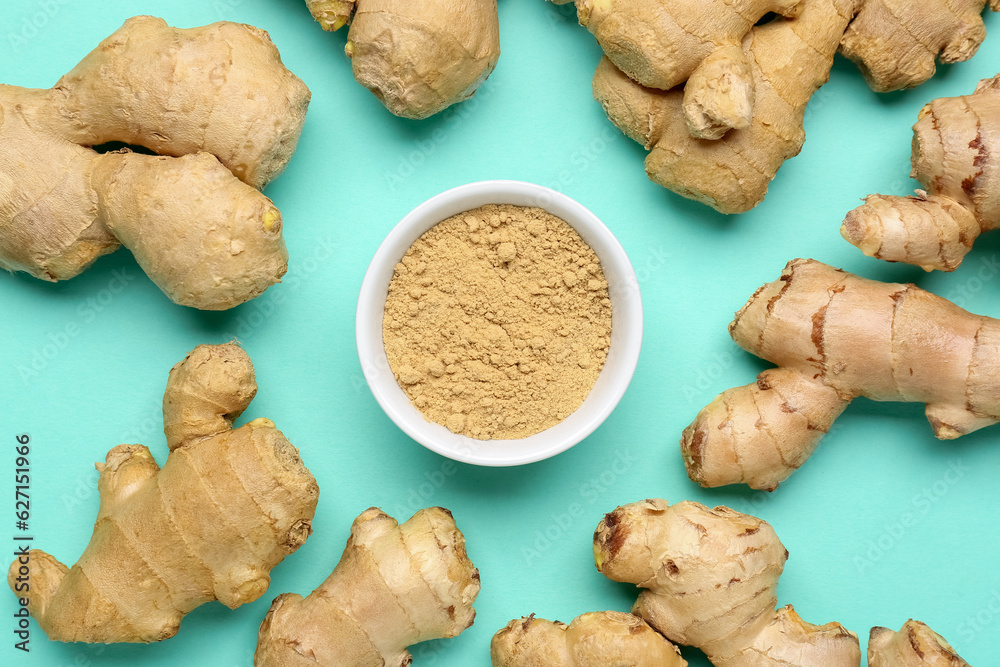 Fresh ginger roots and bowl with dried powder on turquoise background