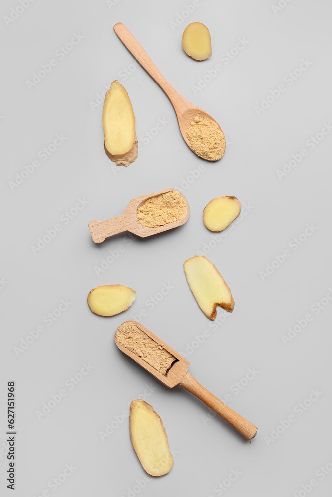 Slices of fresh ginger root, wooden scoops and spoon with dried powder on grey background