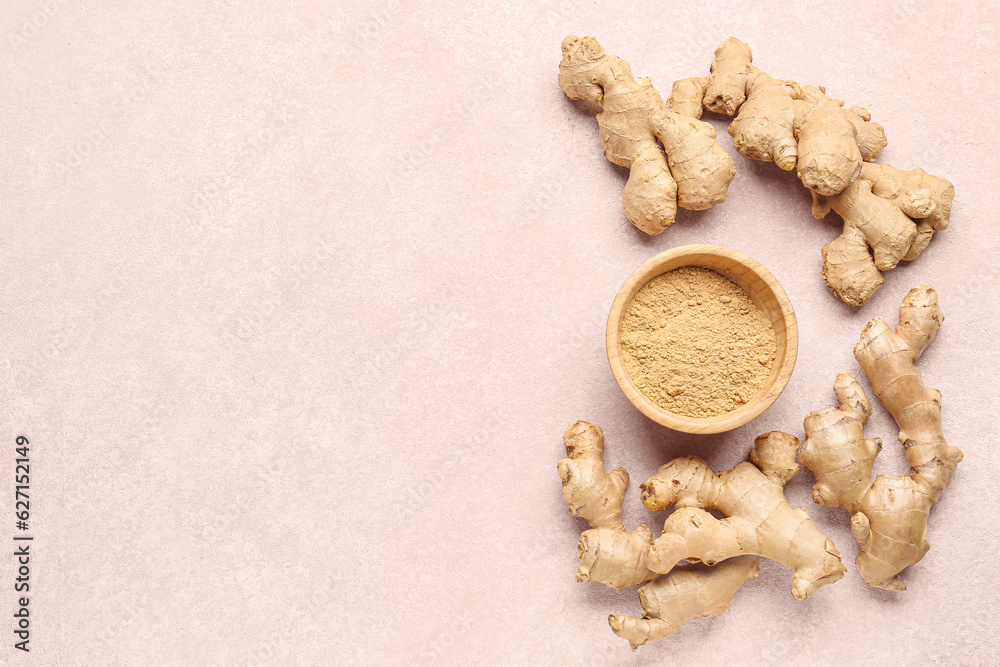 Fresh ginger roots and wooden bowl with dried powder on pink background