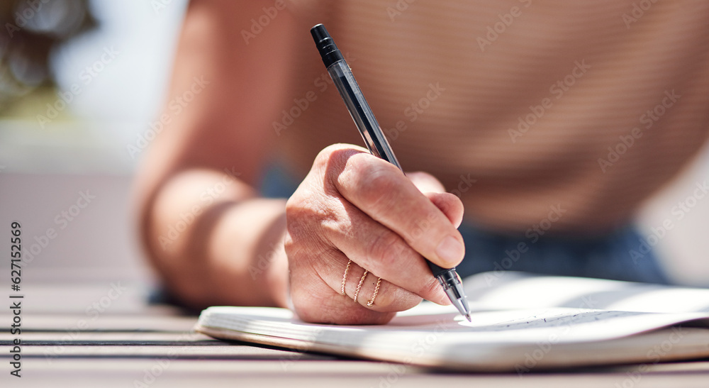 Hand, writing and book with a woman author sitting outdoor in summer for inspiration as a writer. Id