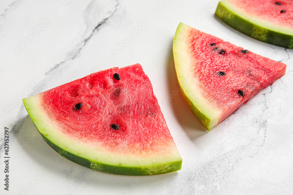 Composition with pieces of fresh ripe watermelon on light background, closeup