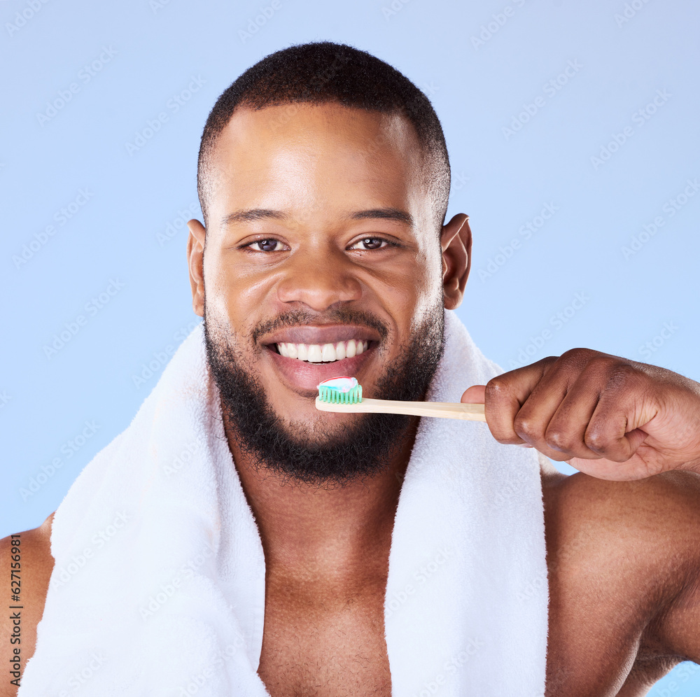 Portrait, black man and brushing teeth in studio for dental, bamboo toothbrush and blue background. 