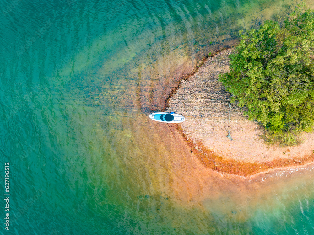 Overlooking the blue lake and islands, SUP board