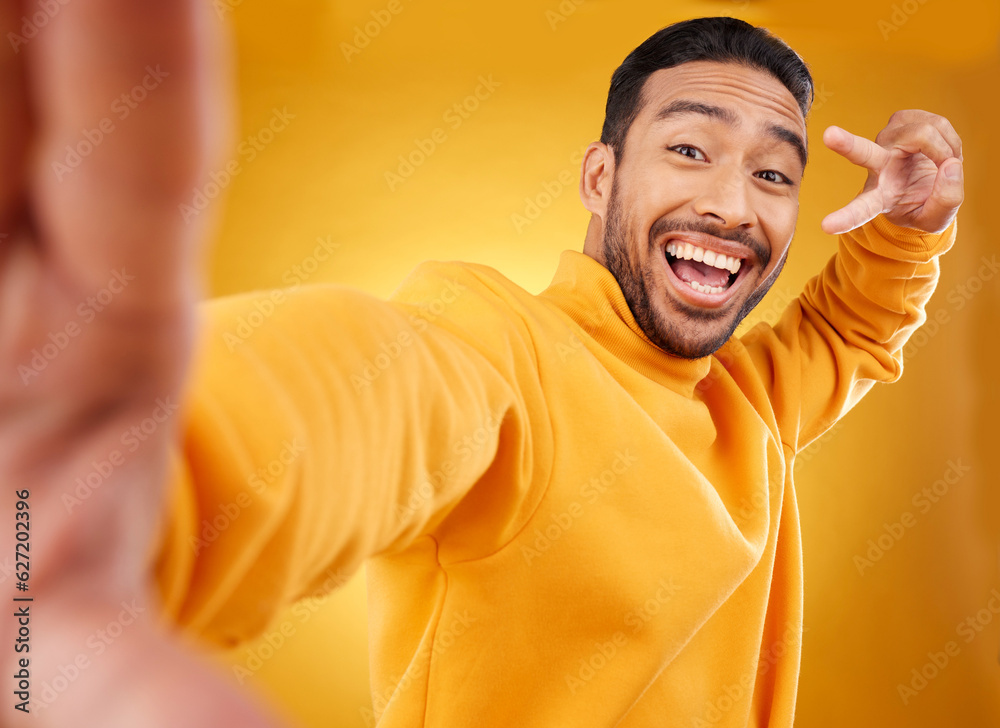 Peace sign, selfie and happy portrait of a man in studio with a hand, emoji and a smile. Male asian 