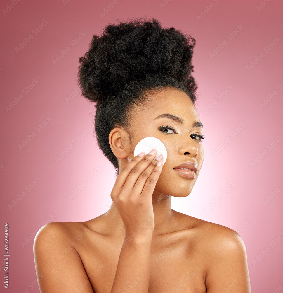 Black woman, cotton pad and portrait with makeup, dermatology and skincare on a studio background. F