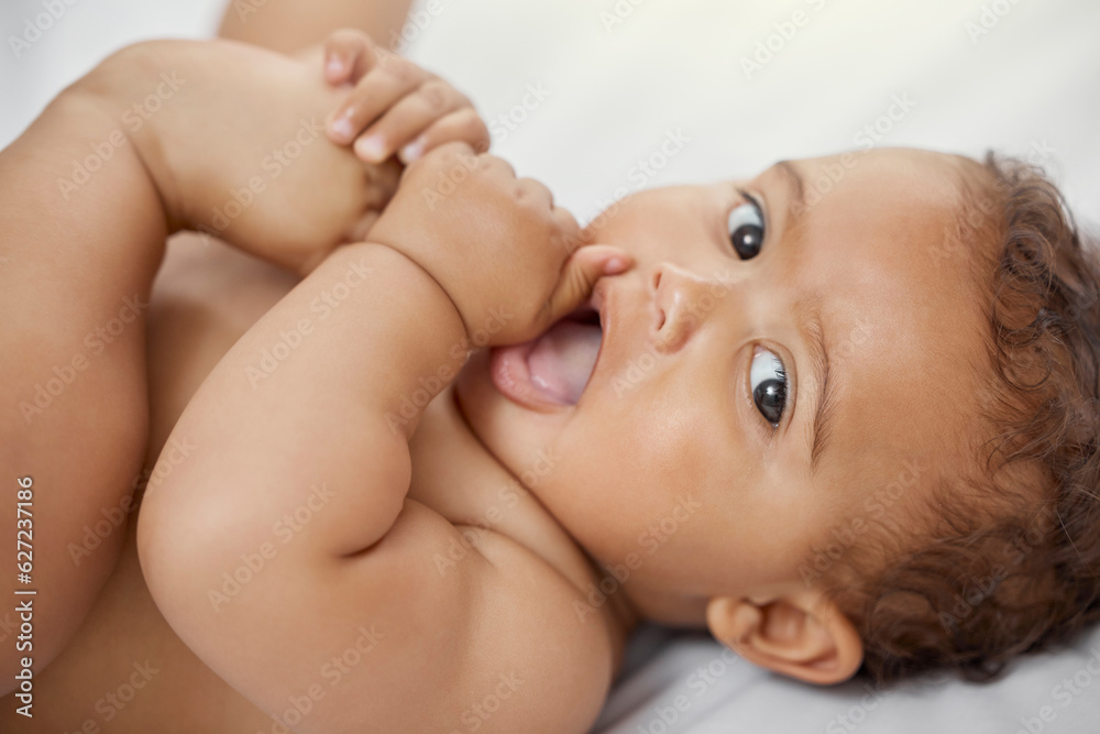 Baby, portrait and child play with feet on bed in home having fun and enjoying time alone. Face, new