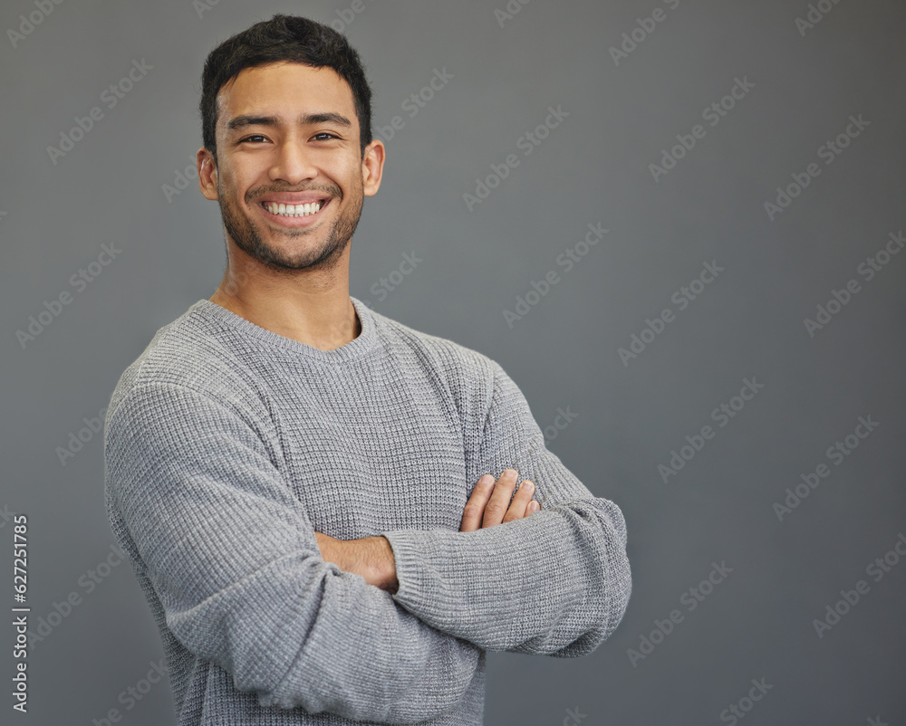 Portrait of happy man in studio with mockup, arms crossed and smile on studio backdrop in casual fas