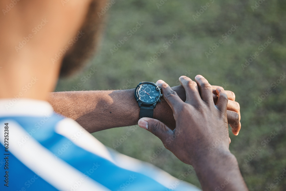 Hands, man or soccer player with smart watch on field to monitor time, training or exercise progress