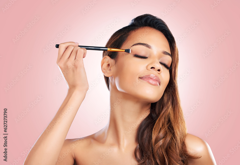 Makeup, eyeshadow and face of woman with brush on pink background for beauty, wellness and luxury. C