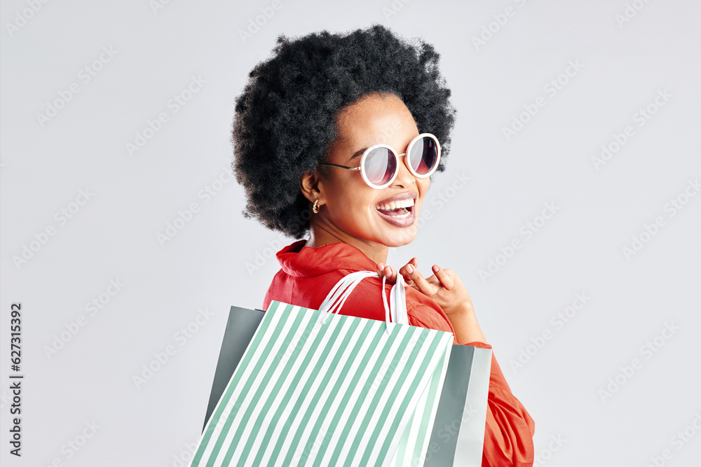 Happy black woman, afro and shopping bags for discount, sale or fashion deal against a white studio 