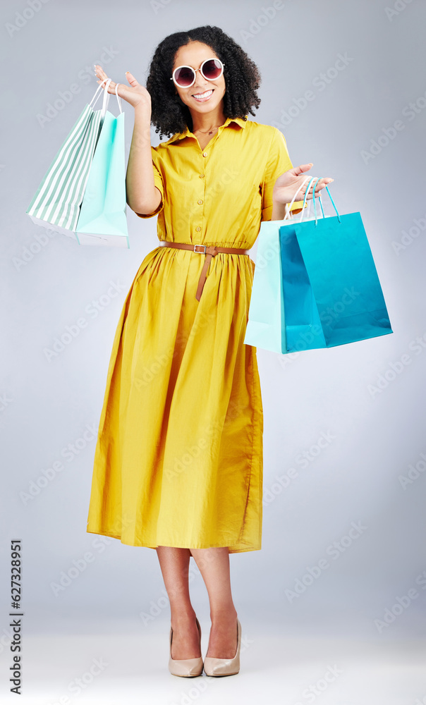 Happy woman, portrait and shopping bags for fashion or style against a white studio background. Exci