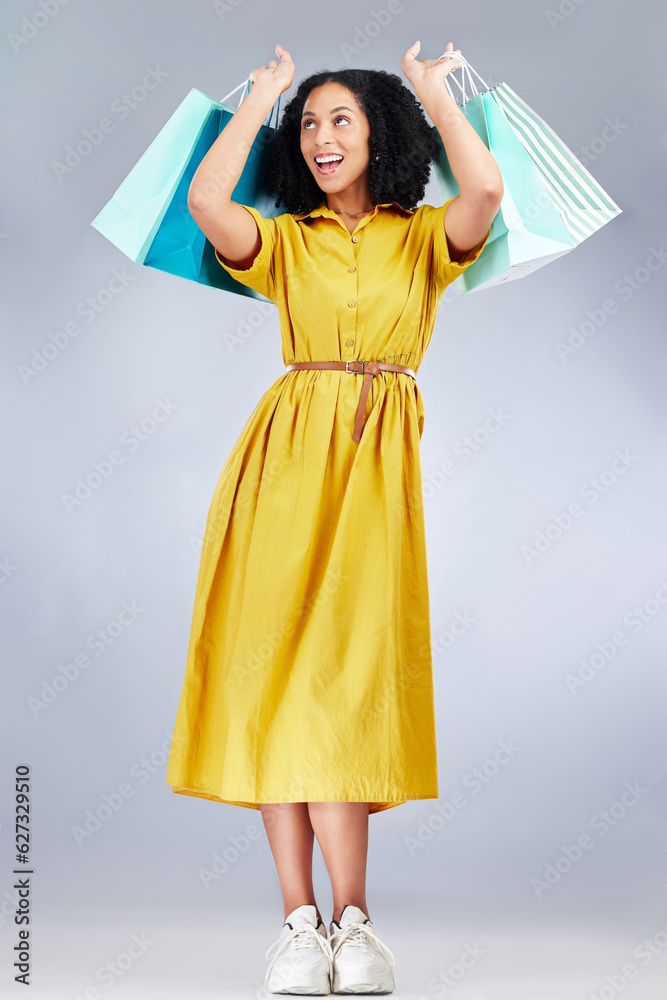 Excited, celebration and woman with shopping bag for fashion in studio isolated on a white backgroun