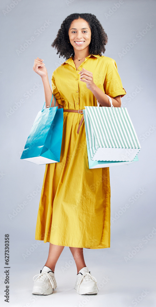 Portrait, smile and woman with shopping bag for fashion in studio isolated on a white background. Ha