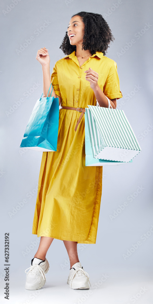 Thinking, smile and woman with shopping bag for fashion in studio isolated on a white background. Ha