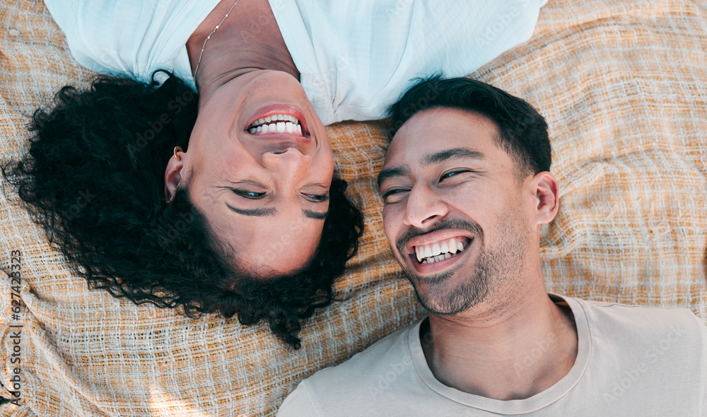 Face, picnic and smile with a couple laughing on a blanket from above, lying on the ground while on 