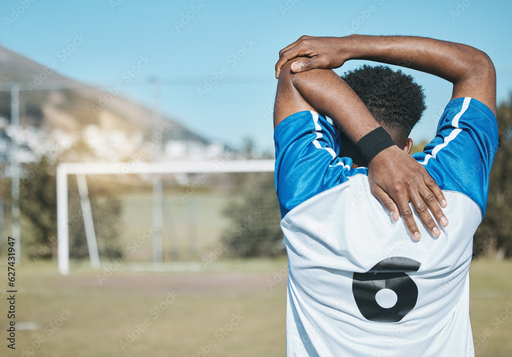 Man, soccer and stretching arm in fitness commitment for match, game or training on grass field outd