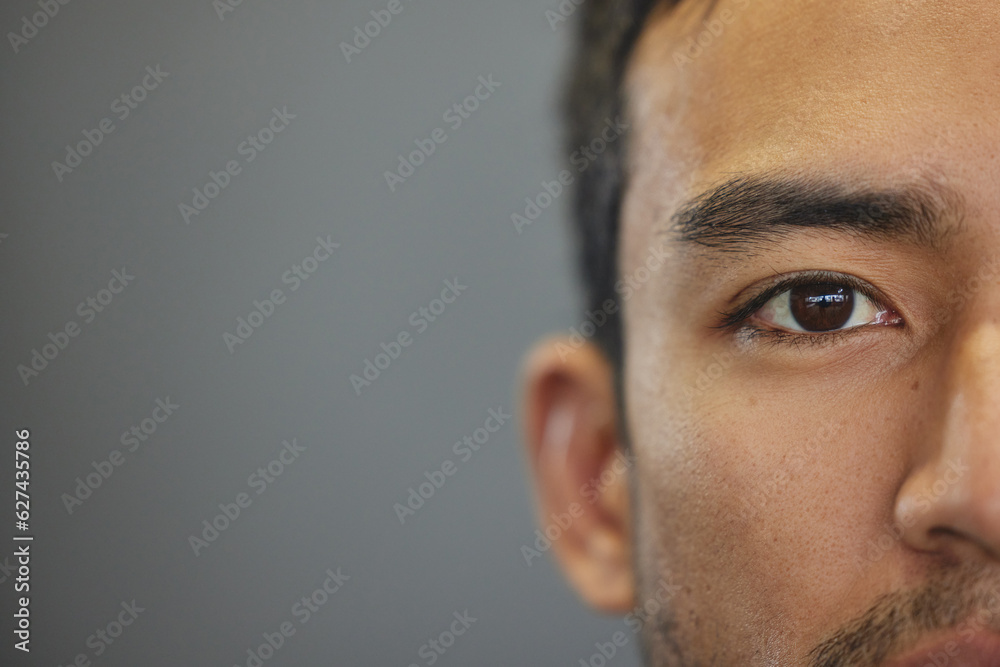 Mockup, portrait and half eyes of a man isolated on a grey background in studio. Serious, Asian and 