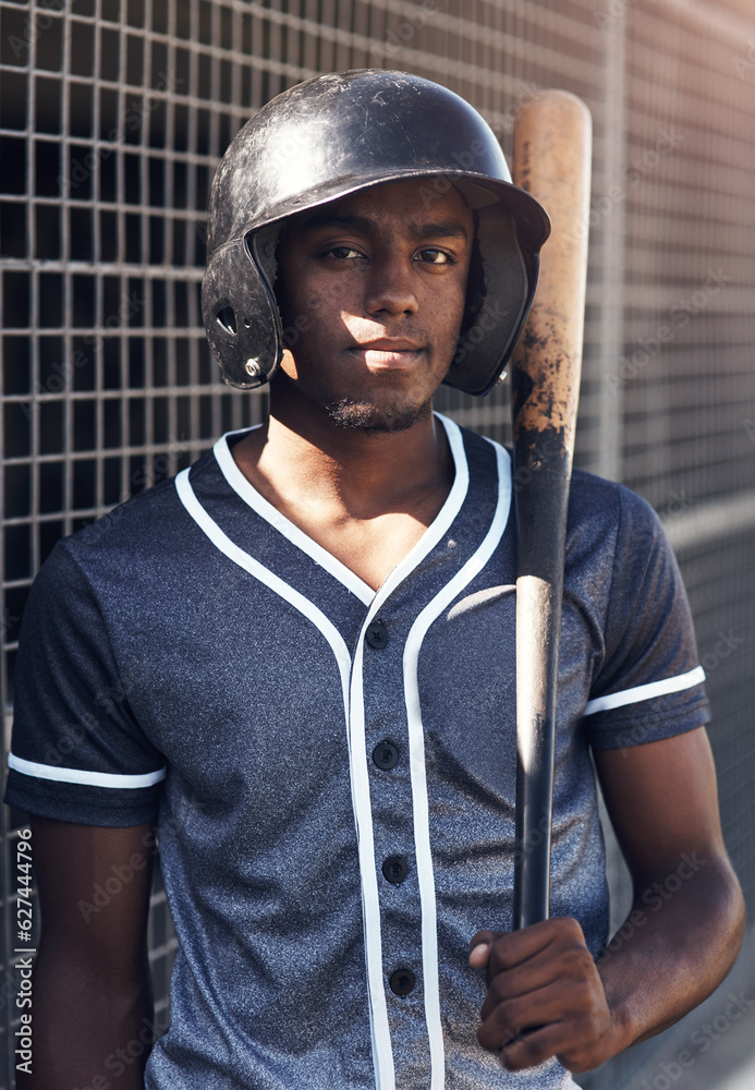 Quitting is not an option. Shot of a young man holding his bat at a baseball game.