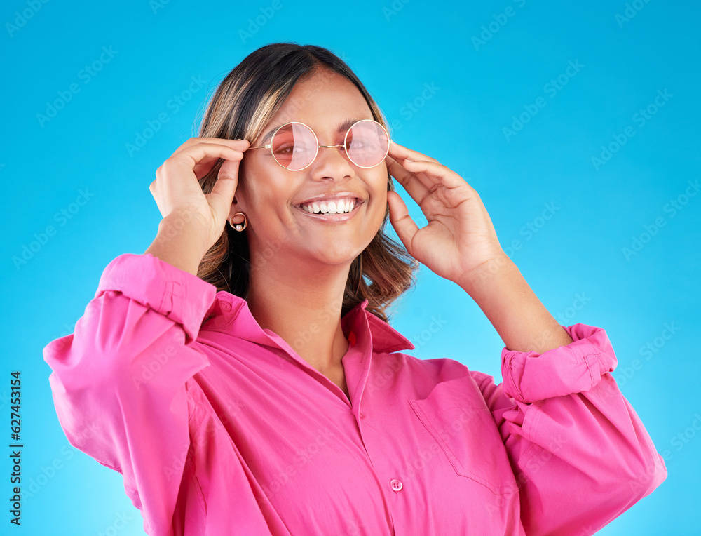 Fashion sunglasses, portrait and woman smile in studio isolated on a blue background. Face, glasses 