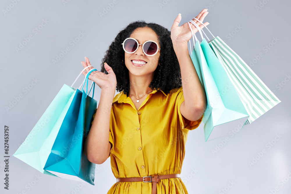 Sunglasses, portrait and woman with shopping bag for fashion in studio isolated on a white backgroun