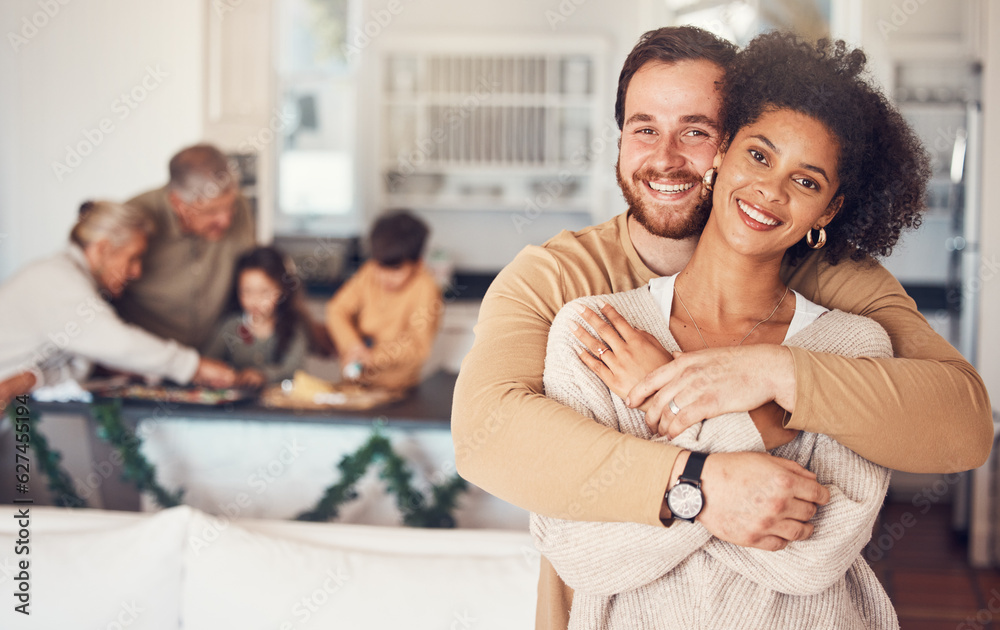 Couple, portrait and hug with love on christmas in family home for quality time with interracial peo