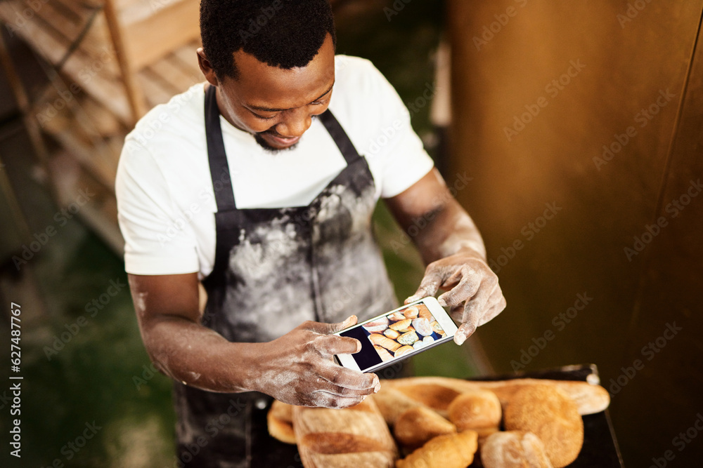 Do something that youre proud of. Cropped shot of a male baker taking a picture on his cellphone of 