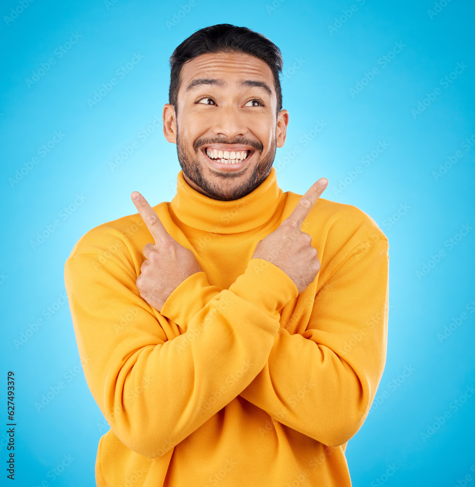 Happy, asian man and hands pointing in studio for choice, deal or sign up decision on blue backgroun