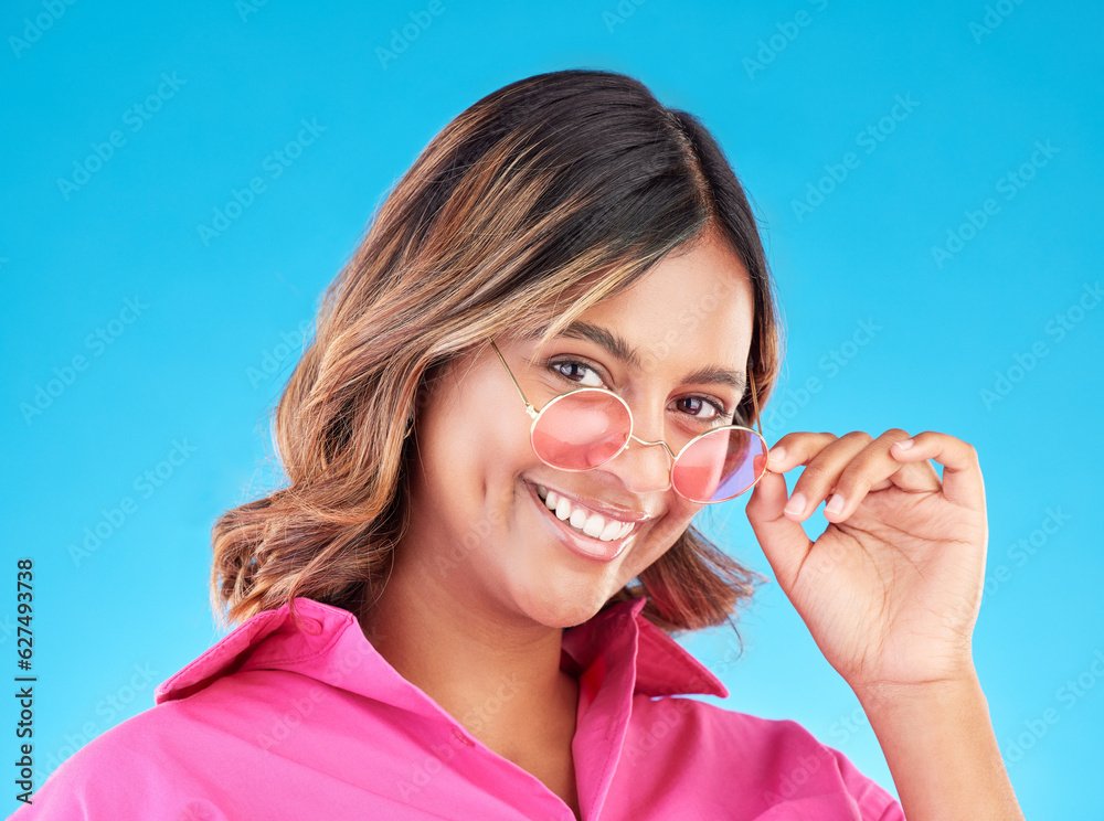 Face, fashion sunglasses and woman smile in studio isolated on a blue background. Portrait, glasses 