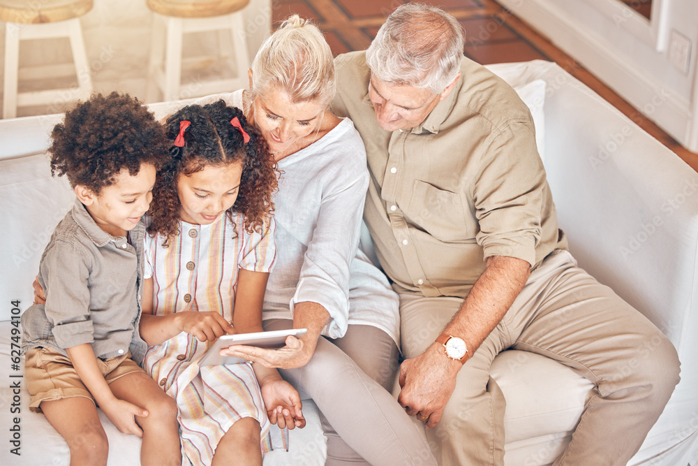 Grandparents, tablet and children in home, learning and bonding together in living room. Technology,