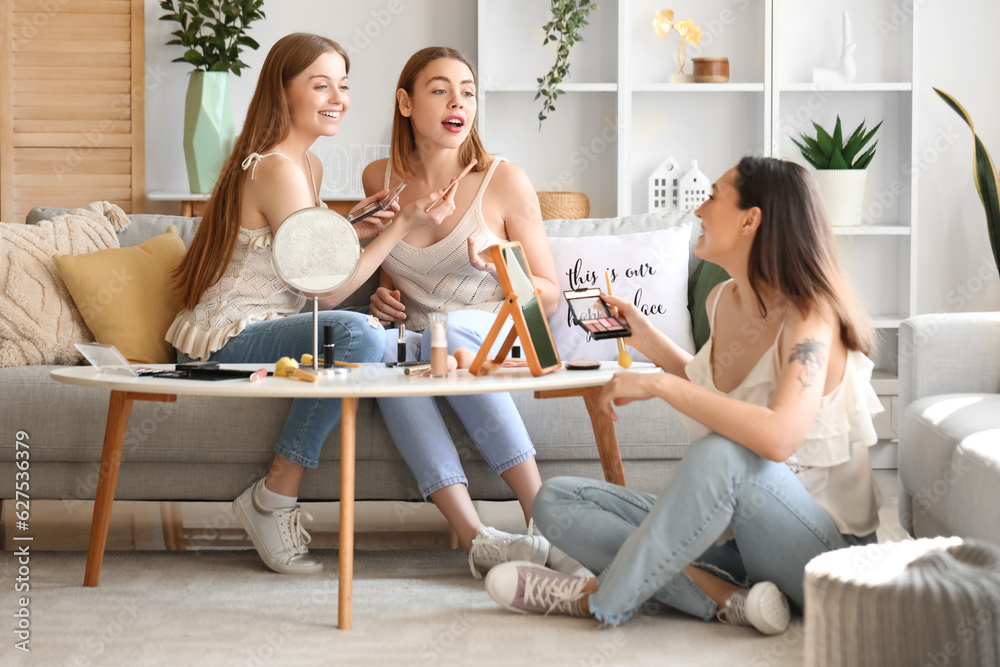 Young women doing makeup at home