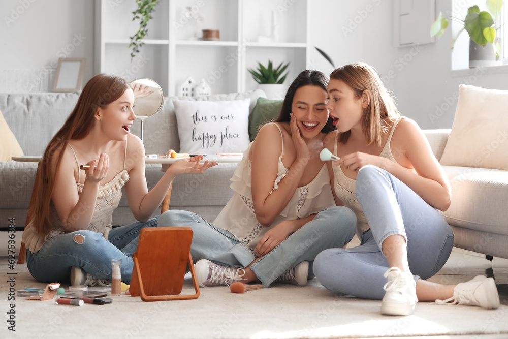 Young women doing makeup at home