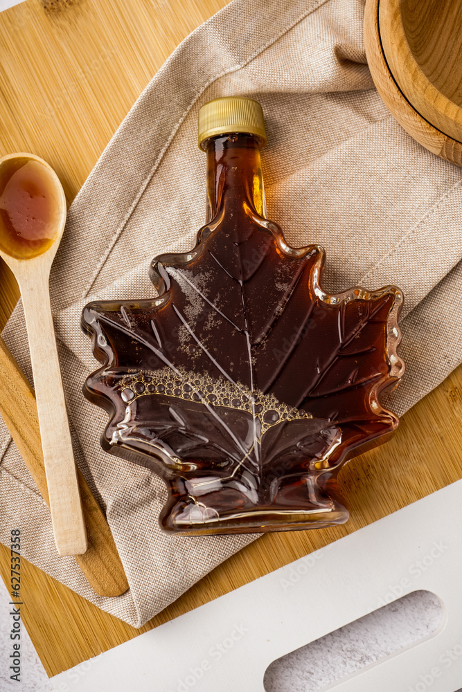 Bottle tasty maple syrup on white table